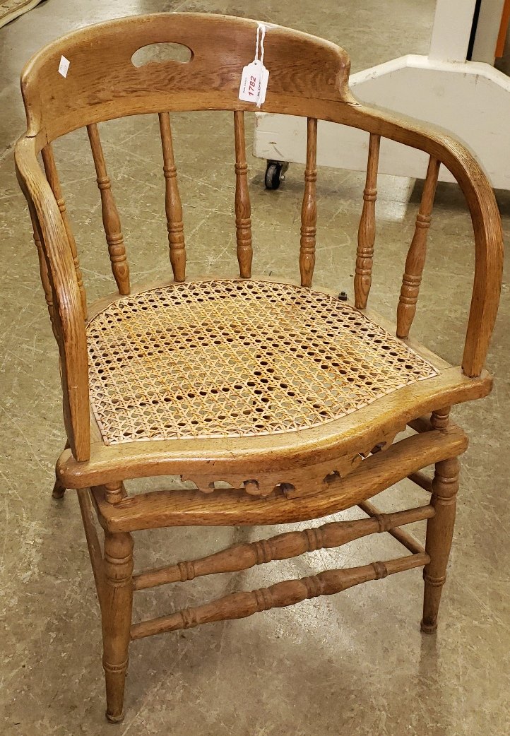 *TURN OF THE CENTURY OAK OFFICE CHAIR: With cane rocking seat.