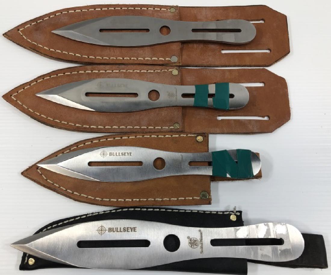 *4 SMITH & WESSON THROWING KNIVES: All with leather sheaths.