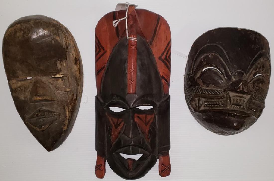 *3 CARVED AFRICAN MASKS: Marked Kenya, Indonesia, and Ivory Coast.