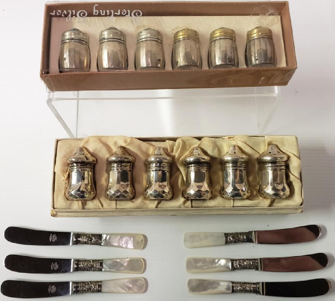 *GROUP OF SILVER AND MOTHER OF PEARL: 12 sterling silver individual shakers and 6 mother of pearl handled butter knives, by Marshall Field's.
