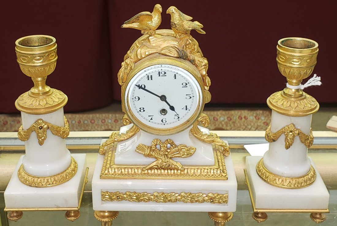 *3-PIECE CLOCK SET: 1 miniature mantel clock fitted with time-only movement, enamel dial having Arabic numeral markers, enclosed in alabaster case with gilt mounts, and pair of matching candlesticks.