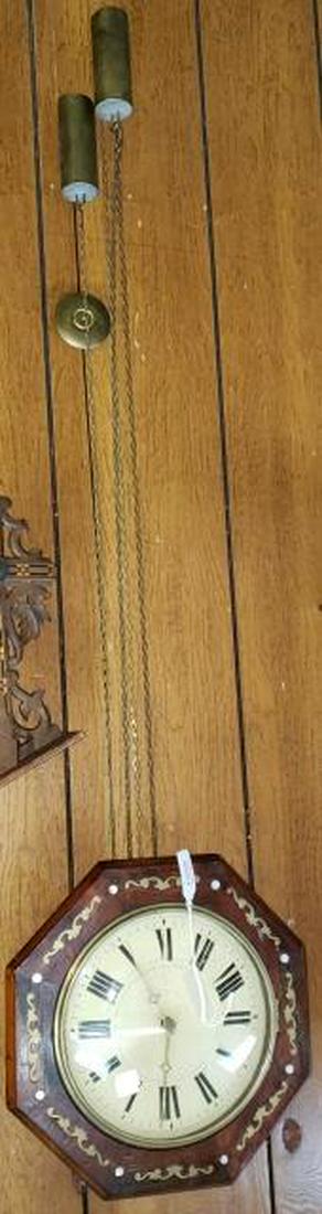 *19TH C. WALL CLOCK: Fitted with time and strike movement, metal dial having Roman numeral markers, enclosed in octagonal case with brass inlay to decoration.