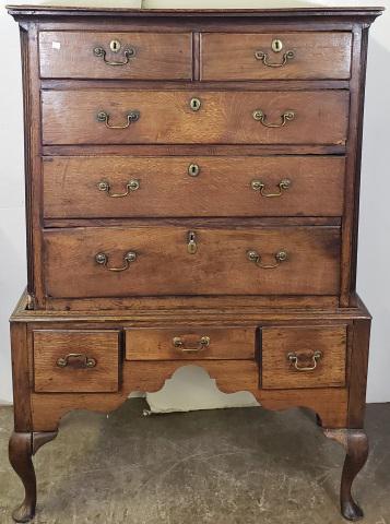 *18TH C. QUEEN ANNE OAK HIGHBOY: Upper section fitted with 2 half drawers over 3 graduated drawers, lower section fitted with 3 drawers and raised on cabriole legs ending in bracket feet, approximate height 60 1/2", width 40", depth 