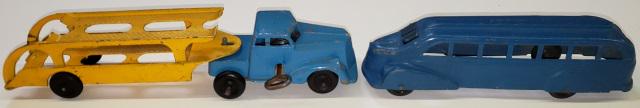 2 TOY TRUCKS: 1 wind-up hauler, blue cab and yellow trailer, approximate length 9 3/8", 1 blue metal bus, marked "Metal Masters Co.", length 7".