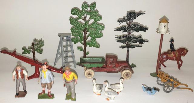 GROUP OF LEAD FIGURES: Including figures, trees, geese, etc., along with vintage cast iron dump truck [possibly Hubley].