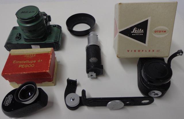 *2 GROUPS OF CAMERA ACCESSORIES: 1 Visoflex II with box, 1 red box for magnifying loupe, 1 Syncroblitzer, 1 replica Nikon F in ceramic material, 35mm camera bracket, and Tokina lens shade.