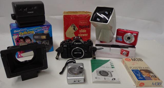 *GROUP OF PHOTOGRAPHY EQUIPMENT: One-Step Talking Polaroid camera, Canon ELPH Junior camera, Samsung BL103 camera with box, box of M3B flash bulbs, Canon A1 camera (S/N: 2260829), checkbox containing ladies' Elgin gold-colored wristw