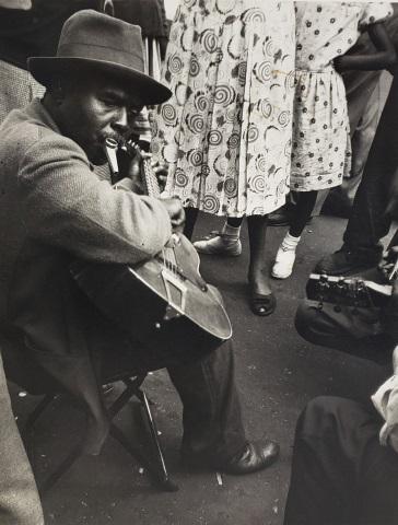 *NATHAN LERNER ORIGINAL GELATIN SILVER PHOTOGRAPH: Nathan Lerner (1913-1997 American), "Guitar Player Maxwell Street, 1936", gelatin silver photograph, created from photographer's original 1935 photo stock, signed and titled in pencil on verso, approx