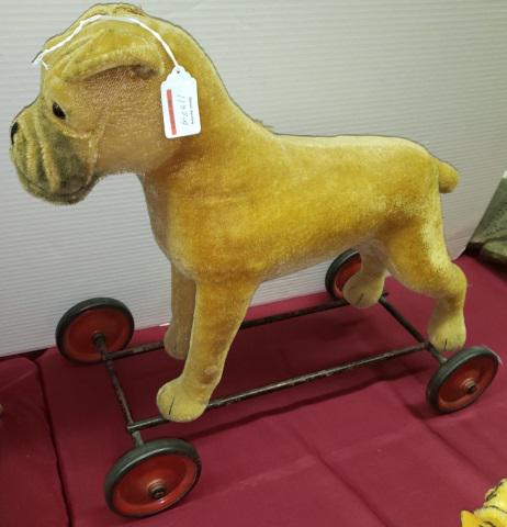 ANTIQUE STEIFF MOHAIR PULL-TOY: Bulldog pull-toy, stands on steel frame with metal and rubber wheels, Growler, has pin in ear and tag on front right leg reading "Made in US-Zone Germany", approximate height 19 1/2", length 21 1/2".