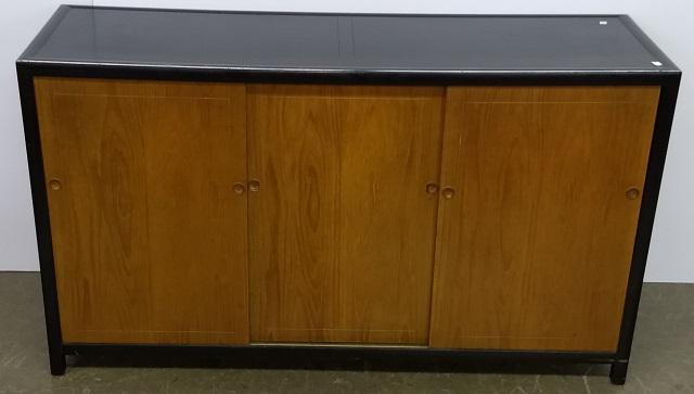 BAKER SIDEBOARD: Having ebony finish with cherry doors, 3 sliding doors opening to shelves and drawers, approximate height 32 1/2", width 57", depth 19".