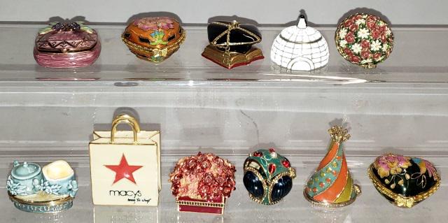 *11 ENAMEL AND JEWELED FIGURAL TRINKET BOXES: Including Macey's bag, graduation cap, beehive, cream and sugar, etc., tallest approximately 1 7/8".