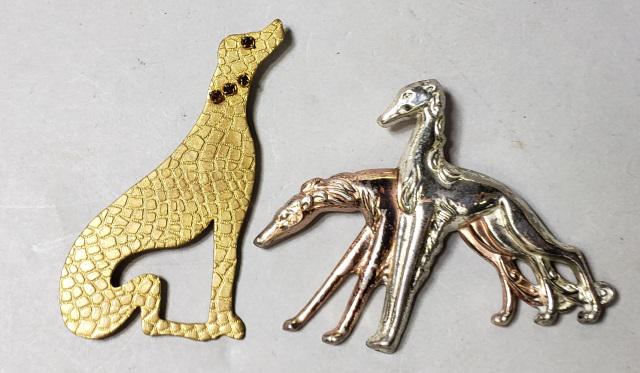 *2 DOG BROOCHES: Sterling silver brooch marked Monet sterling, height 2 1/8", and a an unmarked brooch, dog with jeweled eye and collar, height 2 3/4".