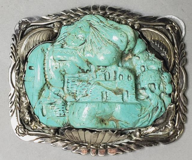 *STERLING AND TURQUOISE BELT BUCKLE: Sterling silver buckle having leaf & beeded decoration, with large piece of carved turquoise, depicting Native American over Adobe, marked on back G, sterling, approximate size 4 1/2" x 3 13/16" x 1 3