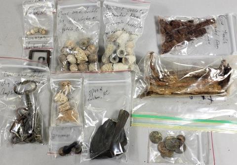 GROUP OF CIVIL WAR RELICS: Rifle butt plate; mini balls, buttons, pieces of artillery, bullets, spoon, and buckles from Kinston, North Carolina; gun tools, bullets, and relics from Confederate and Union battlefield sites in nor
