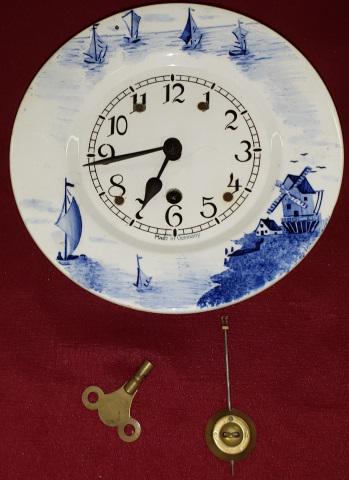 GERMAN KITCHEN WALL CLOCK: Fitted with time only movement, having Arabic numeral markers, decorated with ships and windmill.