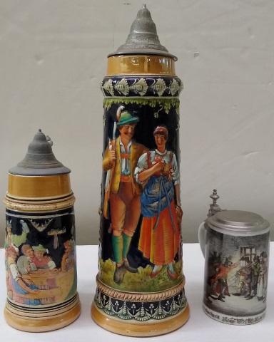 3 STEINS: Stoneware decorated with young couple, approximate height 18 1/4", ceramic decorated with gentlemen drinking beer at table, height 11 1/4", and 1 with 2 panels depicting peasant wedding and "The Secre