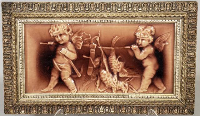 FRAMED ANTIQUE TILE: 2 cherubs carrying game, with glazed finish, tile approximately 6" x 12", frame 8 3/4" x 14 3/4".