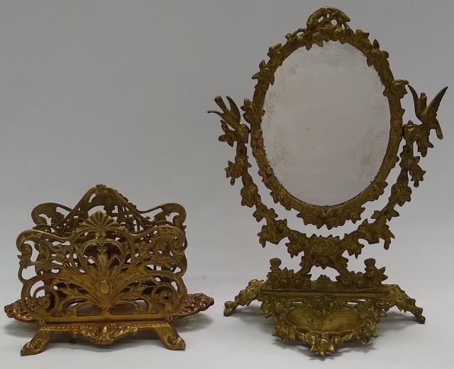 *2 PIECES OF BRASS: Letter rack, approximate height 5 1/2", and boudoir mirror decorated with nude figures, birds, and foliage, height 14 1/2".