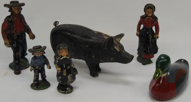 *6 PIECES OF CAST IRON: 4-piece Amish family, duck, and hog.