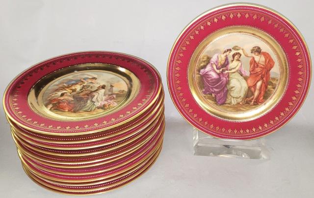 *SET OF 12 ROYAL VIENNA PLATES: Having burgundy border with gilt scroll design, each having different scene, comprising "Diana and Jphigenia, The Rape of Europa, Musik, Venus and Archilles, Musik, The Rape of Europa, Decoration, The