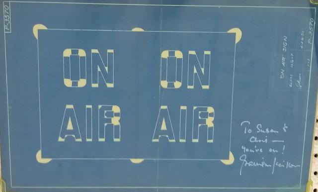 *GARRISON KEILLOR AUTOGRAPH: Signed in white ink on a 17"x11", "ON AIR" blue print, framed between two pieces of glass. Inscription, To Susan & Chris - You're on! Garrison Keillor, Gary Edward "Garrison" Keillor is an American au