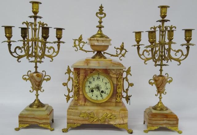 *3 PC CLOCK GARNITURE SET: Mantle clock fitted with time and strike movement, having enamel dial with Arabic numeral markers, enclosed in onyx and gilt metal case, over animal paw feet, approximate clock height 17 1/2", togethe