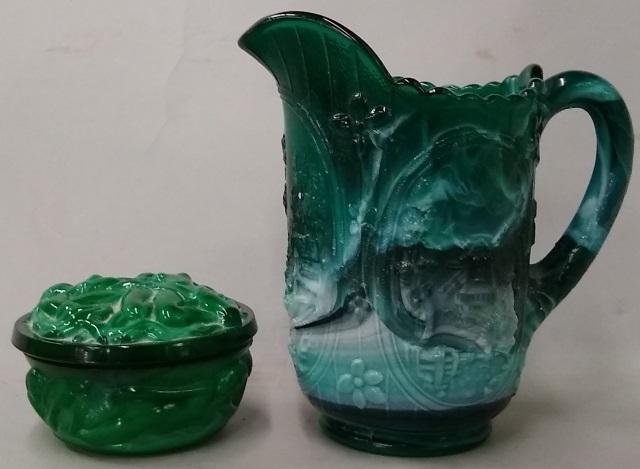 *2 PIECES: Malachite pitcher decorated with sea, approximate height 6 1/2", and dresser jar decorated with relief dancing nudes, height 2 1/2".