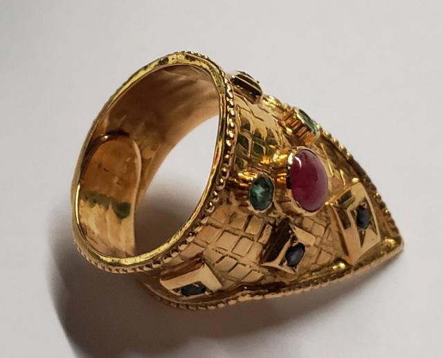 *18K YELLOW GOLD RING: Byzantine style, set with a colored cabochon cut gemstone, marked 750, approximate total weight 5.5DWT.