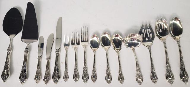 *82-PIECE SET OF LUNT STERLING SILVER FLATWARE: Eloquence pattern, 12 dinner forks, 12 salad forks, 12 teaspoons, 12 coffee spoons, 12 hollow-handled dinner knives, 12 hollow-handled butter knives, and 10 serving pieces.