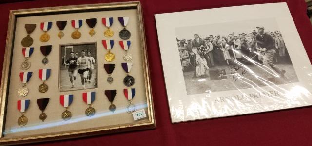 *2 PIECES: Photograph depicting Arnold Palmer driving at St. Andrews 1960, signed "To Victor, best wishes, Arnold Palmer", and 21 framed cross country medals.