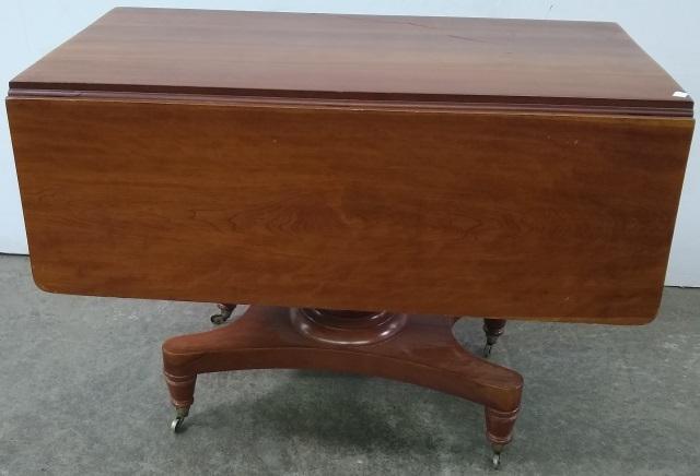 19TH C. MAHOGANY DROP LEAF TABLE: Raised on pedestal base.