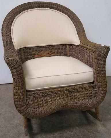 WICKER ROCKER: With cream upholstered back and seat.
