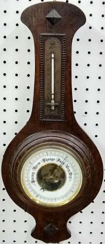 *20TH C. BAROMETER/THERMOMETER: Enclosed in oak case.