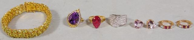 *8 PIECES OF STERLING SILVER JEWELRY: Ring with amethyst stone, child's earrings, ring with faux ruby, chain link bracelet, ring with faux diamonds, and heart-shaped post earrings.
