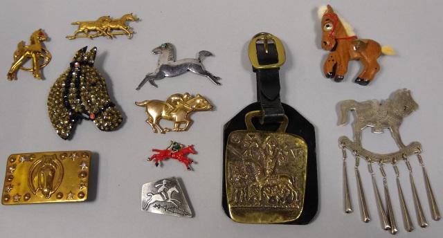 *GROUP OF COSTUME JEWELRY: Brooches, belt buckle, and token.