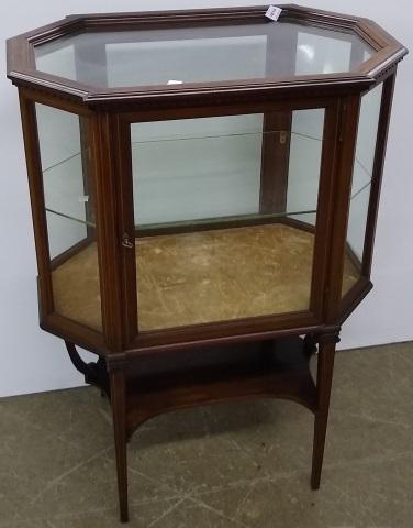 *HEPPLEWHITE STYLE VITRINE TABLE: Having hexagonal form and fitted with single glazed door, over platform stretcher.