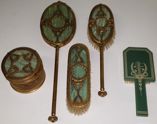 *5 PIECES OF DRESSER ACCESSORIES: 4 with slag glass green panels, hair brush, clothing brush, hand mirror, dresser box, together with aluminum dresser box, with musical movement.