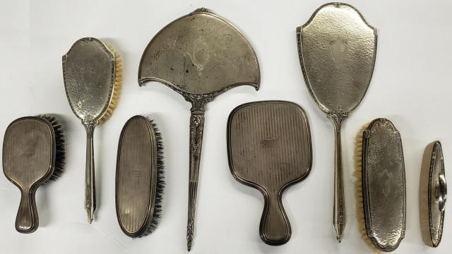 *8 PIECES OF DRESSER ACCESSORIES: 3 hand mirrors, 4 brushes, and a nail buffer.