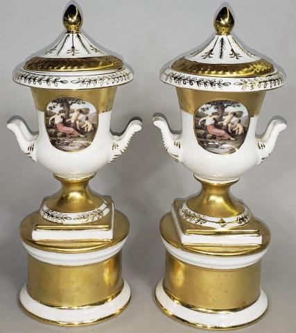 *PAIR OF KPM COVERED URNS: Contemporary KPM, decorated with beauty and attendants, having gilt highlights, approximate height 10 7/8".