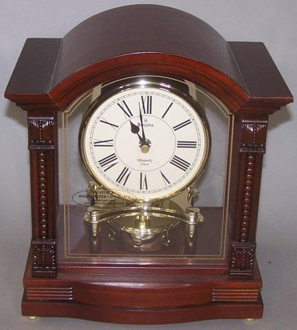 *PERIOD STYLE MANTEL CLOCK: By Bulova, having metal dial, with Roman numeral markers, with rhapsody chimes, battery operated approximate height 10 1/2", width 9 1/2", depth 6 3/4".