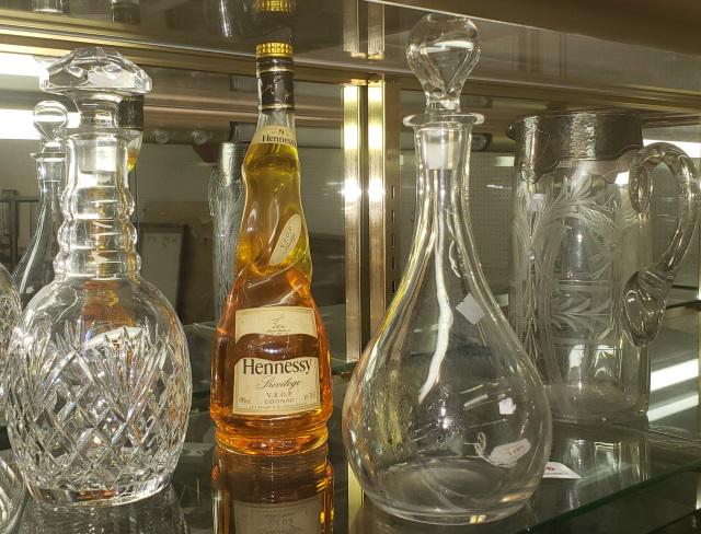 *4 PIECES OF GLASS: 2 decanters, 1 Val St. Lambert decanter, etched pitcher with silver overlay, Hennessy bottle (bottle only, colored water inside), tallest piece 12 1/4".
