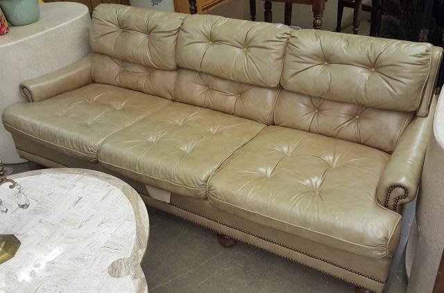 *BROWN LEATHER SOFA: Having tufted upholstery, approximate height 30", width 32", depth 82".
