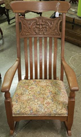 ROCKER: With slat back, carved mask and leaf panel, approximate height 44 1/4".