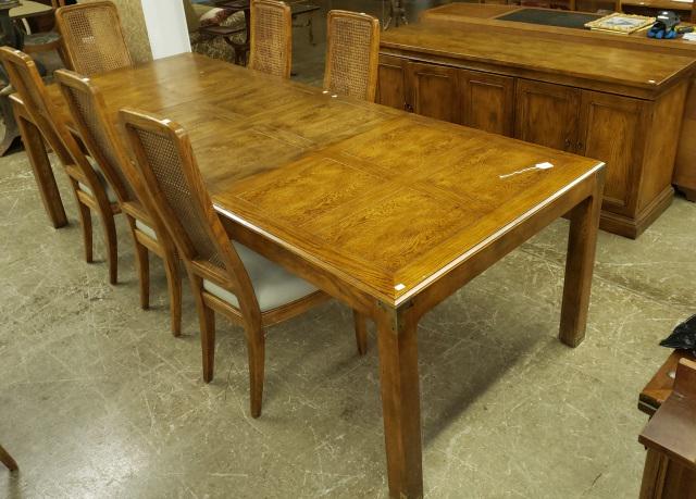 *8-PIECE OAK DINETTE SET: By Artefacts Henredon, 6 side chairs with cane backs, table complete with 3 leaves, sideboard fitted with 2 doors opening to 3 drawers and double doors.