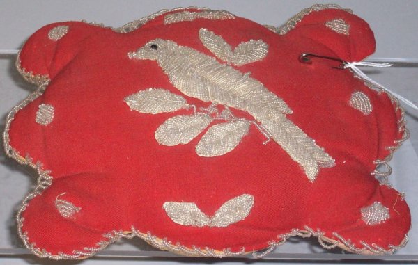 IROQUOIS BEADED PIN CUSHION: Having bird and leaf decoration on red cloth, approximate length 8", height 6".