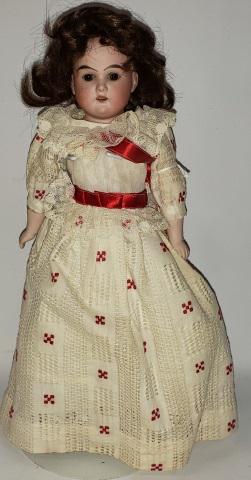 *ARMAND MARSEILLE BISQUE DOLL: Bisque shoulder head doll, Floradora, having set eyes with open mouth and teeth, on leather hinged body with bisque arms, marked on back Floradora A. 5/0 M., approximate height 15".