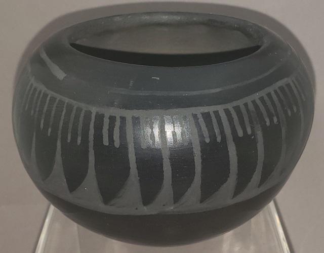 SAN ILDEFONSO PUEBLO POTTERY JAR: Alfred Aguilar, San Ildefonso Pueblo, black on black pottery jar, with feather design, signed on bottom, approximate height 3", diameter 4 1/2".