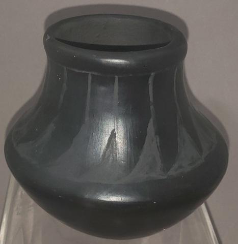 SAN ILDEFONSO PUEBLO POTTERY JAR: Yellowbird, San Ildefonso Pueblo, black on black pottery jar, with feather design, signed on bottom, approximate height 3 3/8", diameter 3 5/8".