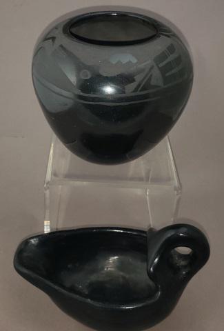 2 PIECES OF BLACK POTTERY: Including Alfred Aguilar, San Ildefonso Pueblo, black on black pottery jar, with feather and animal design, approximate height 3 3/4", diameter 4 3/8", along with a unsigned black pottery sauce boat w