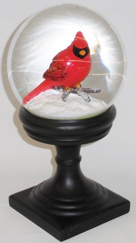 SNOW GLOBE ON STAND: Having internal cardinal figure, approximate height 11 1/2".